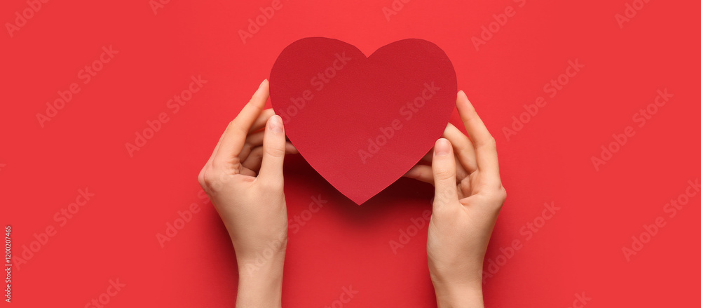 Female hands with red paper heart on color background. Valentine's Day celebration Female hands with red paper heart on color background. Valentine's Day celebration