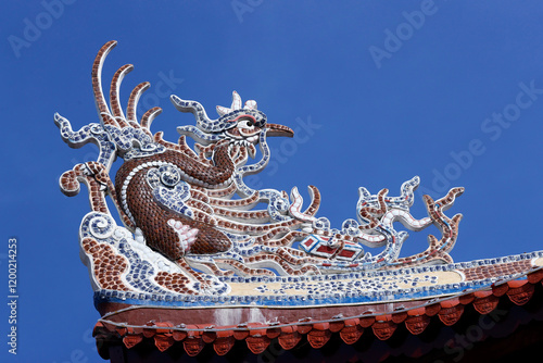 Thien Truc buddhist pagoda. Roof decoration with Chinese dragon.  Bac Lieu. Vietnam. . photo