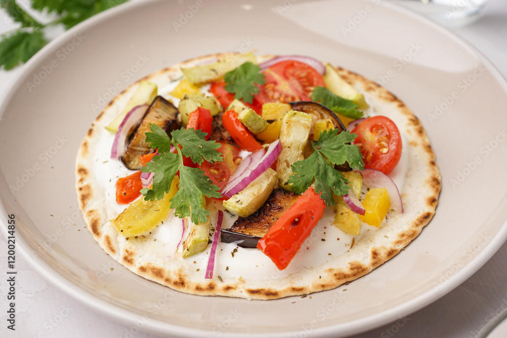 Plate of tasty pita bread with grilled vegetables on white background Plate of tasty pita bread with grilled vegetables on white background