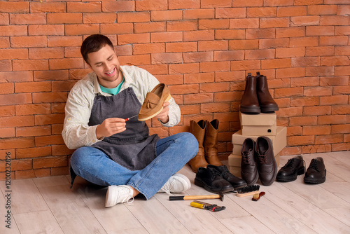 Male shoemaker repairing sh...