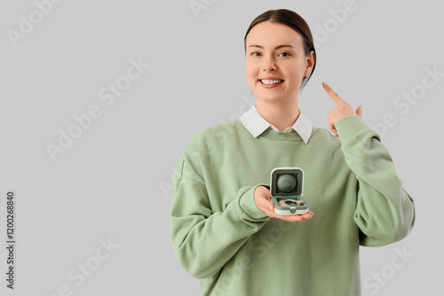 Young woman with hearing ai...