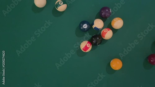 pool balls in triangle shape on green table. white ball dispersing the group of balls., game start, first shot, ease out movement, flat lay, tow down, copy space
