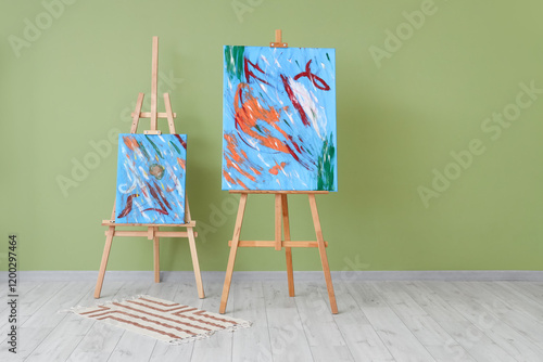 Paintings on easels near gr...