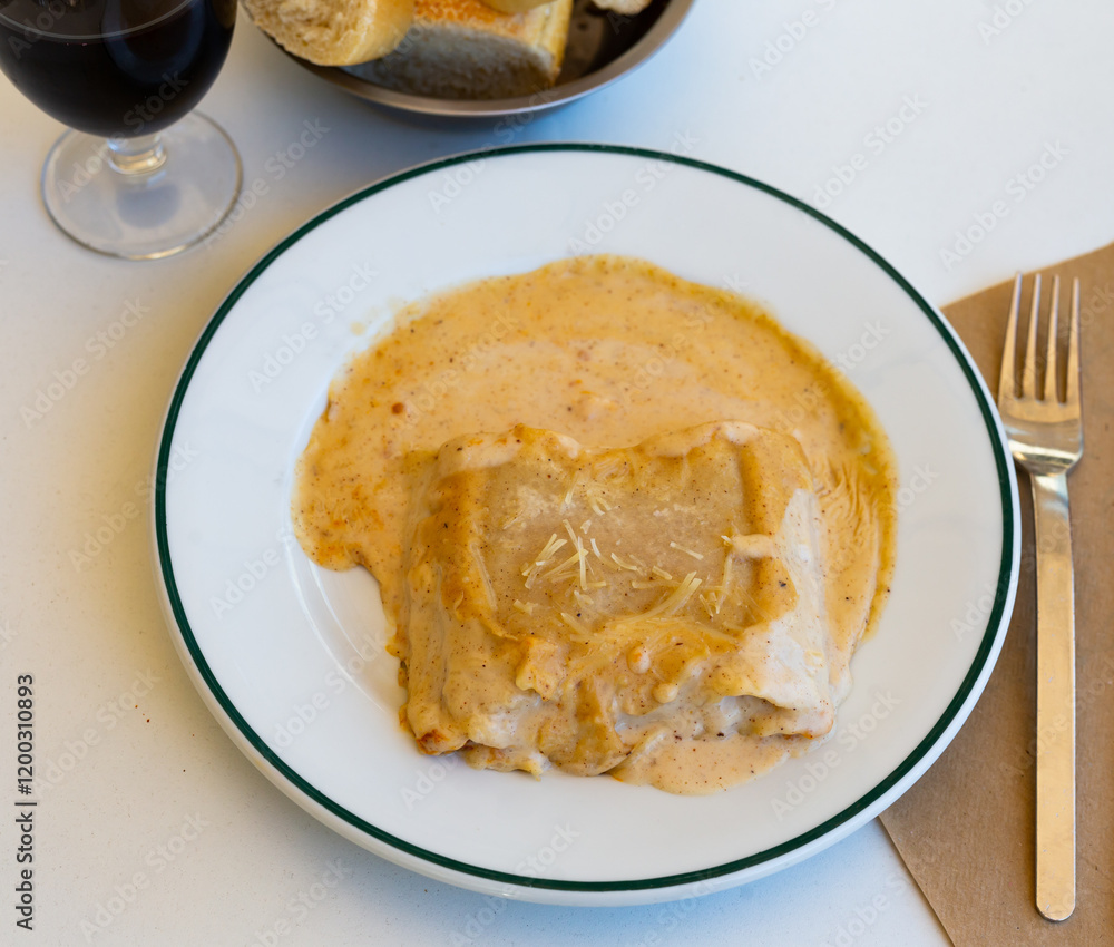 Popular meat dish of Italian cuisine is lasagna with veal under a delicious sauce and cheese sprinkled on top Popular meat dish of Italian cuisine is lasagna with veal under a delicious sauce and cheese sprinkled on top