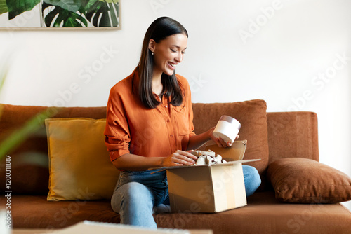 Obraz na płótnie Satisfied lady received package, unpacking cardboard beauty box with cosmetics a