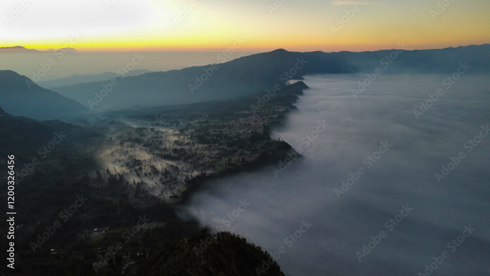 Fototapeta premium Fog creating a mystic scenery at sunrise, seen from above