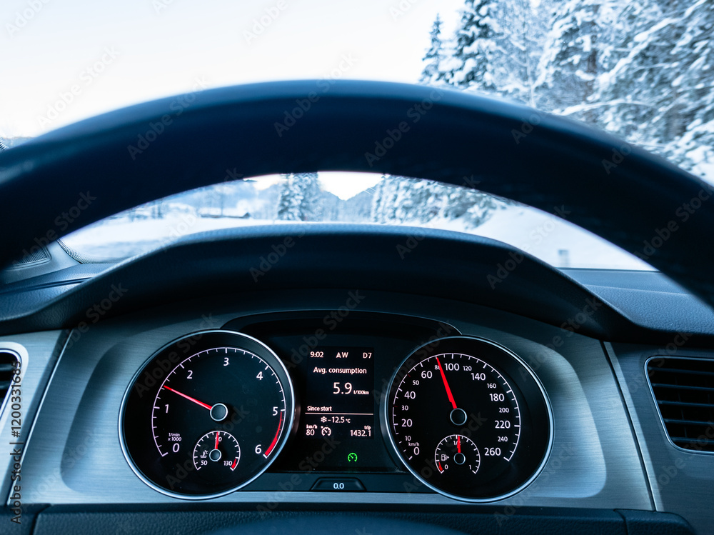 Car dashboard on winter cold day on mountain road with snow and ice