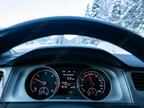 Obraz na płótnie Car dashboard on winter cold day on mountain road with snow and ice w salonie