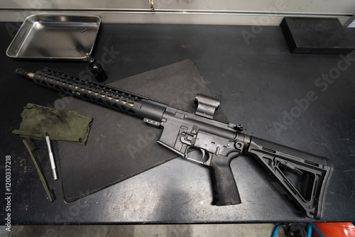 Rifle Ar 15 with red dot in the gunsmith's workshop on the table, close-up photo. photo