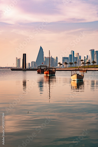 Wooden tour ships at seaside in Doha Qatar and cityscape with skyscrapers in the background