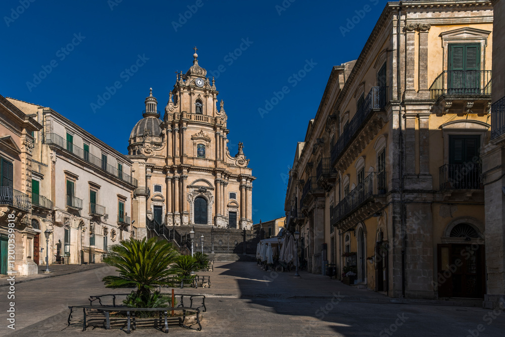 Fototapeta premium The central square of Ragusa Ibla with the majestic Duomo di San Giorgio. A stunning blend of Baroque architecture and Sicilian charm, capturing the essence of this UNESCO World Heritage site.