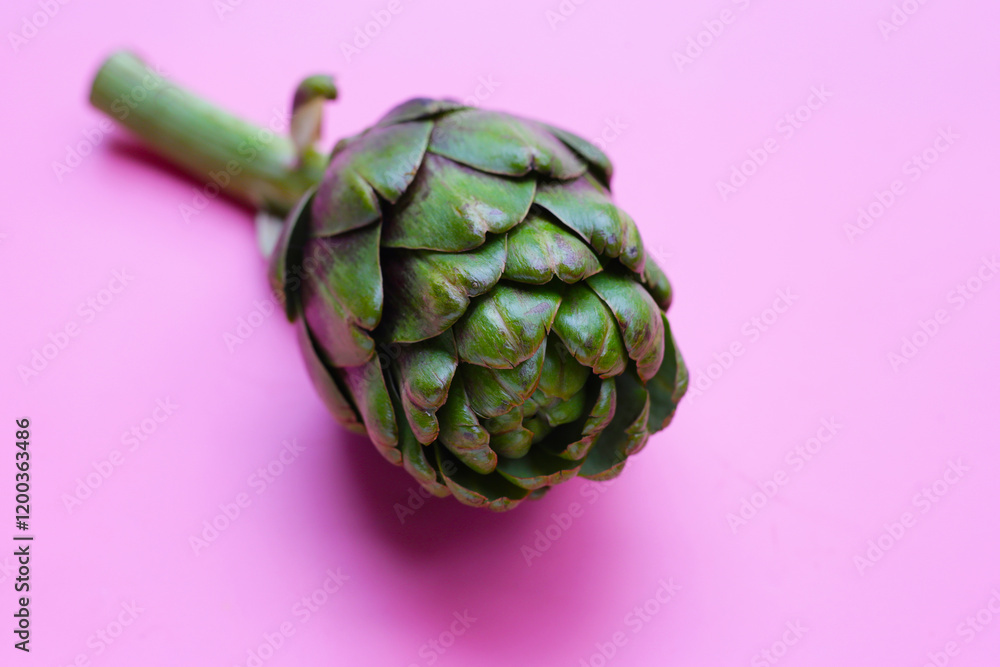 Fototapeta premium Purple artichoke on pink background.