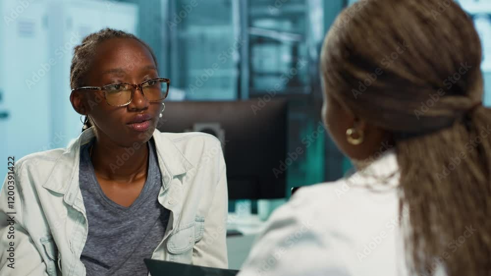 Female physician and patient examining health care reports focusing on cancer diagnosis, radiation therapy and wellbeing strategies to combat illness in a professional clinic setting. Camera A. Female physician and patient examining health care reports focusing on cancer diagnosis, radiation therapy and wellbeing strategies to combat illness in a professional clinic setting. Camera A.