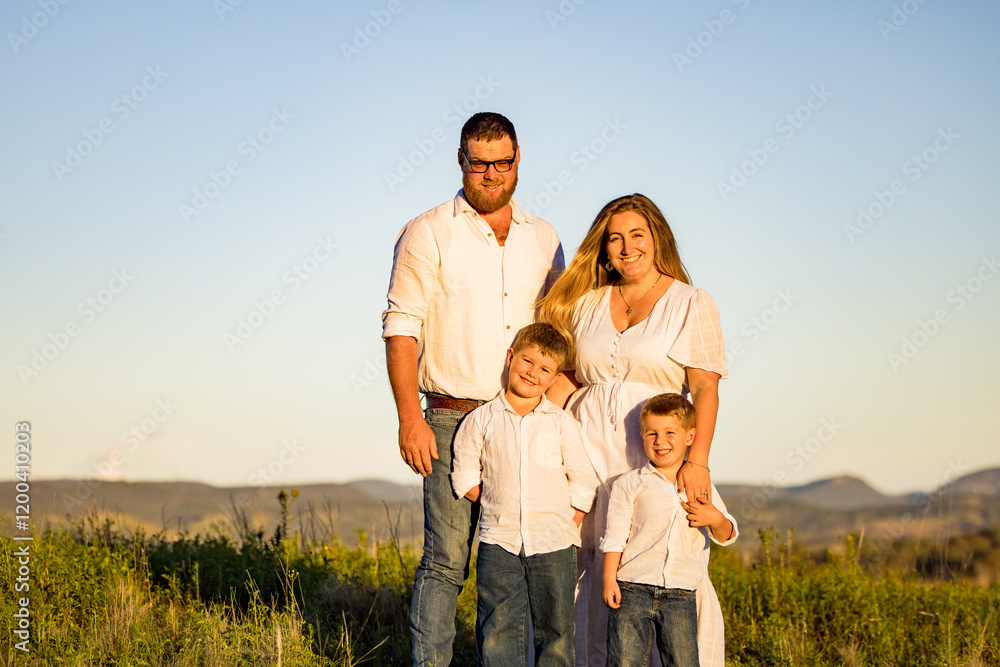 Family portrait on hilltop with blue sky background Family portrait on hilltop with blue sky background