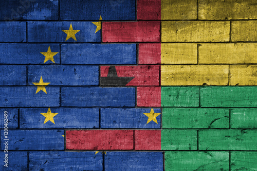 colourful painted big flag of european union and flag of guinea bissau on a massive old brick wall background. concept photo