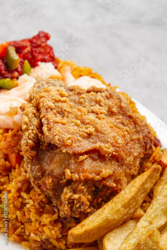 broaster chicken and homemade fries with rice and sweet and sour chicken with a marble grey background photo