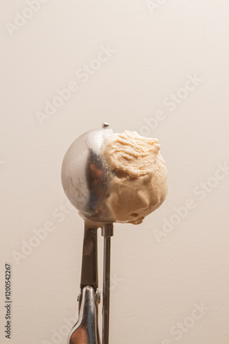 ice cream scoop with ice cream, beige background