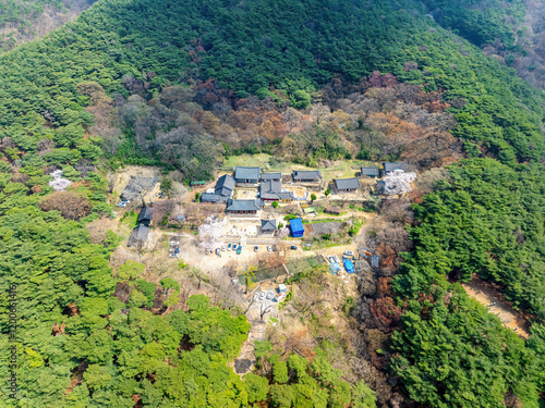 Sinchang-ri, Seosan-si, Chungcheongnam-do, South Korea - April 5, 2024: Aerial and spring view of Buddhist sanctuary of Gaesimsa Temple amid trees on mountain photo