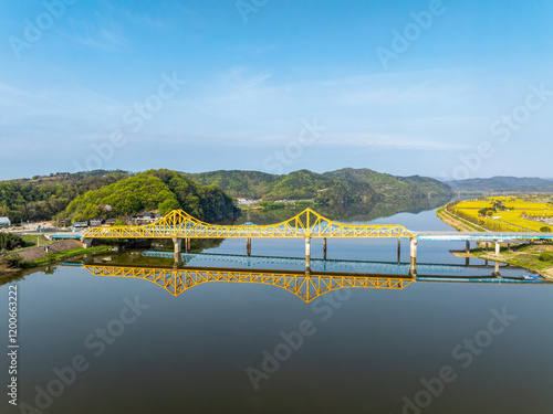 Namji-ri, Changnyeong-gun, Gyeongsangnam-do, South Korea - April 10, 2024: Aerial and spring view of Namji Bridge and Namji Railroad Bridge on Nakdong River photo