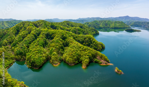 Aerial and spring view of Yongdamho Lake with green trees on mountain with ridges near Jinan-gun, South Korea photo