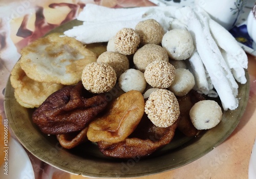 Assamese food known as pitha and laru prepared during Bihu festival in Assam. Laru is prepared with coconut and sesame seeds. Pitha is prepared with rice flour and other ingredients. photo