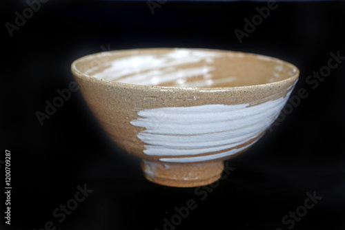 Mansan-dong, Sangju-si, Gyeongsangbuk-do, South Korea - April 22, 2024: Close up of a ceramic bowl for Matcha(powdered tea) against black background at Sangju pottery photo