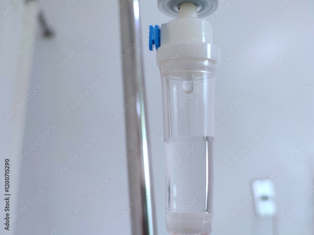 Close-up view of medical intravenous drip in hospital treatment room Close-up view of medical intravenous drip in hospital treatment room