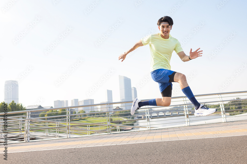 Fototapeta premium Happy young man jumping in a park