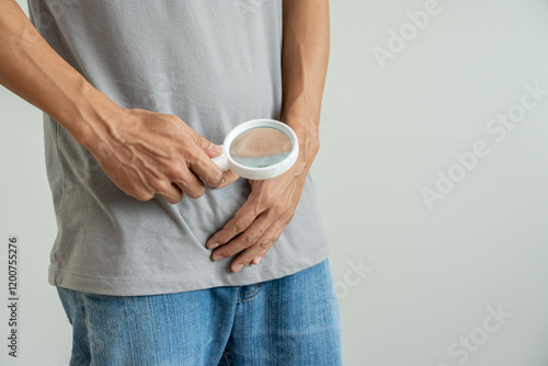 Obraz na płótnie Man uses magnifying glass for size problems, discomfort from disease and inflammation