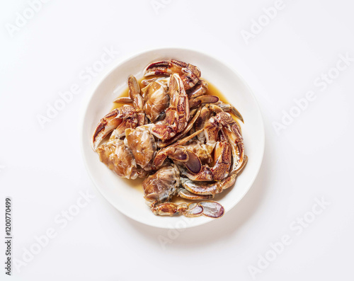 Close up and top angle view of Ganjang-gejang(Soy sauce marinated crab) with yellow crab on dish and white floor, South Korea photo