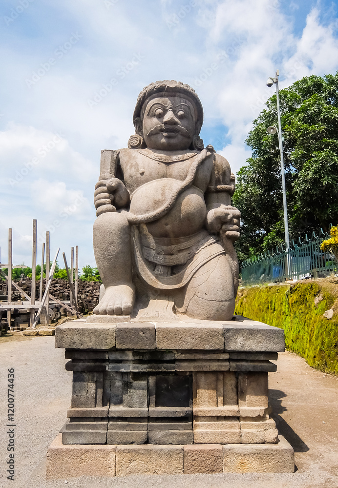 Dwarapala statues in Prambanan Temple area, in Sleman, Special Region of Yogyakarta, Indonesia. The staute is a doorkeeper or guardian of the entrance gate to the temple. Dwarapala statues in Prambanan Temple area, in Sleman, Special Region of Yogyakarta, Indonesia. The staute is a doorkeeper or guardian of the entrance gate to the temple.