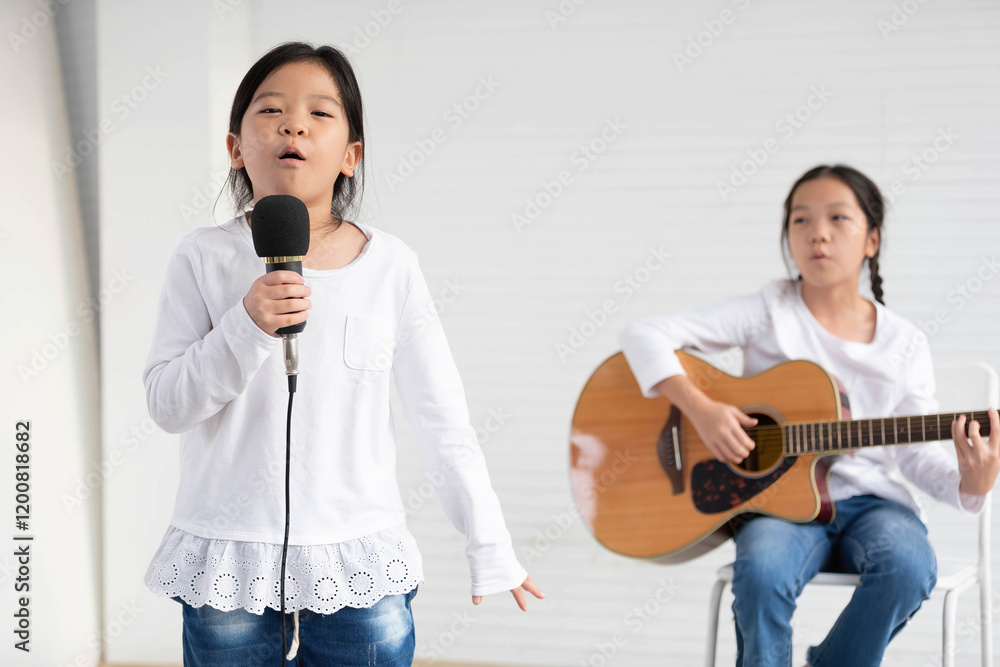 Girls singing song and playing guitar in the classroom Girls singing song and playing guitar in the classroom