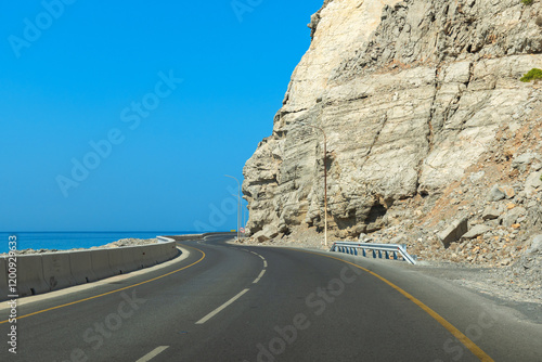 Scenic coastal road along the cliffs of Musandam, Oman photo