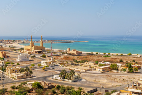 coastal view of Bukha city with traditional architecture and a mosque, Musandam, Oman photo