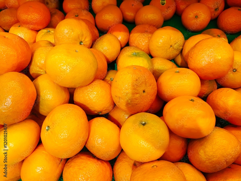 a bunch of fresh oranges on display for sale in the supermarket a bunch of fresh oranges on display for sale in the supermarket