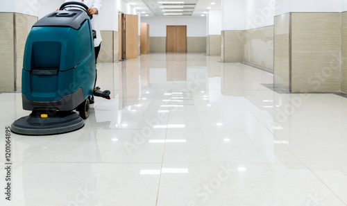 Woman using scrubber machine wash the floor