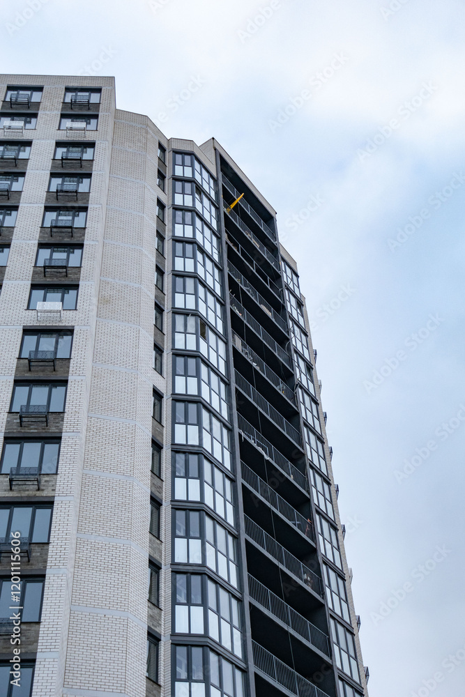 A tall building with many windows and a balcony A tall building with many windows and a balcony