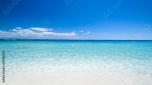 Azure Serenity: Crystal-clear turquoise water laps gently against a pristine white sandy beach under a vibrant blue sky dotted with fluffy white clouds. photo