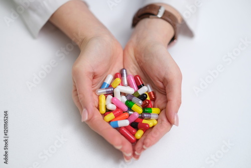Obraz na płótnie A detailed closeup image of hands holding a vibrant and varied collection of colorful pills and capsules w salonie