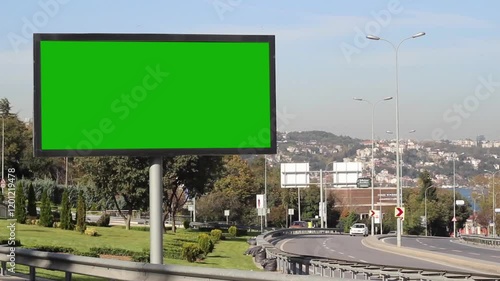 Advertising billboard green screen on sidelines of expressway with traffic