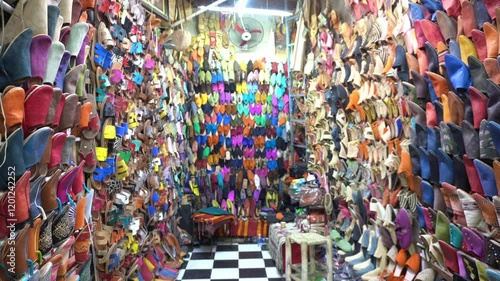 Africa, Morocco, Marrakech 12,29,2024 walking in the traditional suk, souk market inside the Medina in Jemaa el fna square heritage world , tourist attraction destination , 
leather slippers and shoes photo