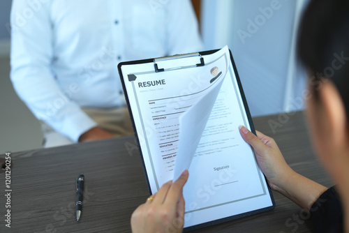 Tableau sur toile A female office executives woman hand holding resume, talk to job applicants for job interviews about careers in the meeting room to analyze data before job interviews regarding personnel recruitment