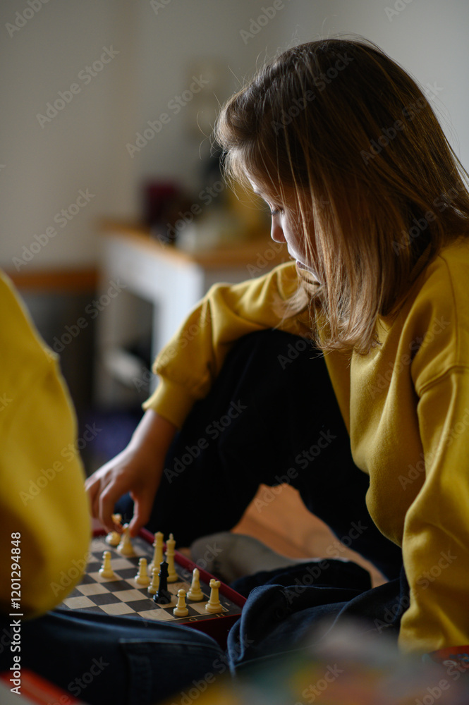 A boy and a girl play chess together, focused and engaged in the game. The scene reflects concentration and friendly competition, showcasing the fun of strategic thinking and mental challenge. A boy and a girl play chess together, focused and engaged in the game. The scene reflects concentration and friendly competition, showcasing the fun of strategic thinking and mental challenge.