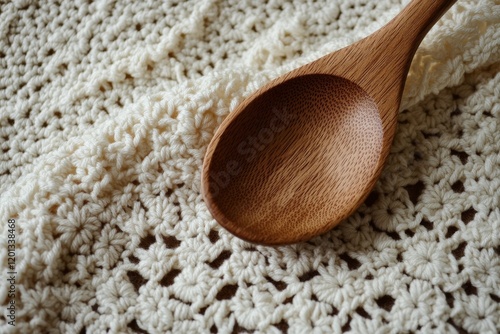 Elegant wooden spoon resting on a soft textured cloth in a kitchen setting