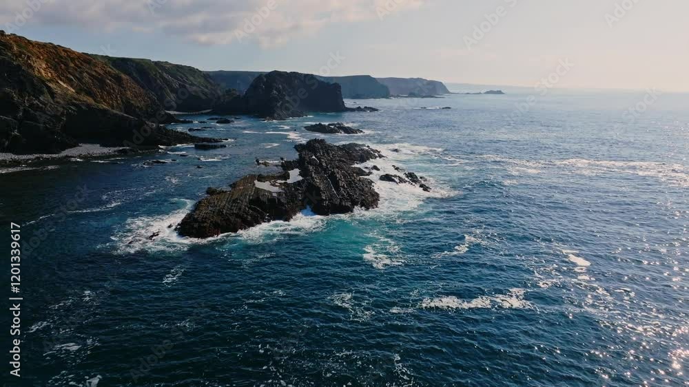 The turquoise waters of the atlantic ocean contrasting against the dramatic cliffs and coastline of Portugal The turquoise waters of the atlantic ocean contrasting against the dramatic cliffs and coastline of Portugal