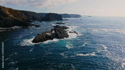 The turquoise waters of the atlantic ocean contrasting against the dramatic cliffs and coastline of Portugal photo