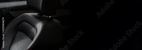 A close up of a car seat with a black background
