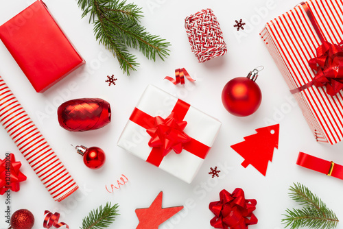 Handmade wrapped christmas gift boxes with stuff on color background, top view