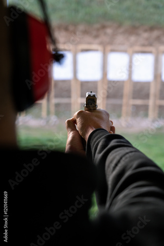 Ταπετσαρία Close-up of handguns displayed on green table at shooting range, including a pistol with silencer