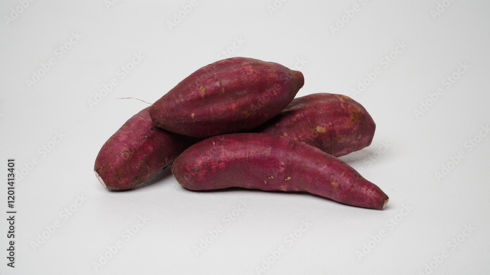 A group of Japanese sweet potatoes isolated on white background. A group of Japanese sweet potatoes isolated on white background.
